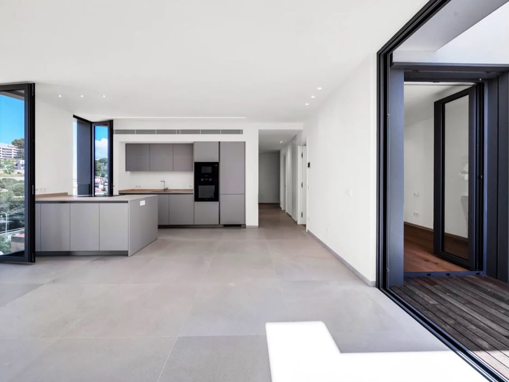 Salón con cocina abierta y salida a la terraza